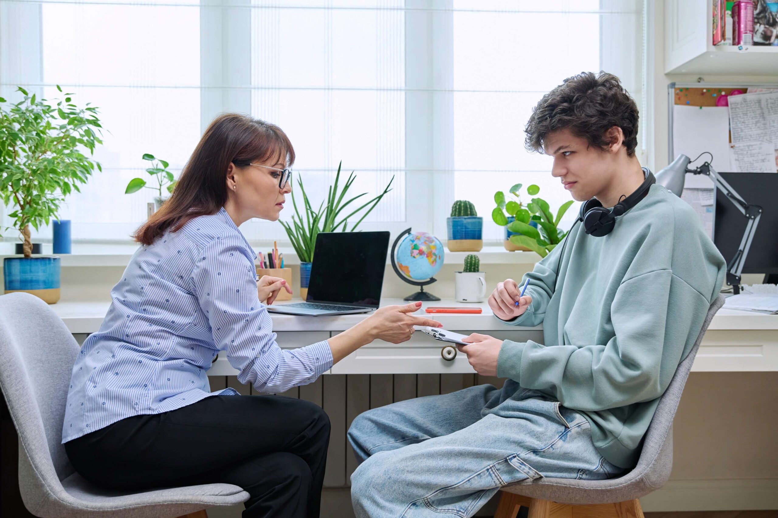 Teen engaged in behavioral services activity with a therapist.