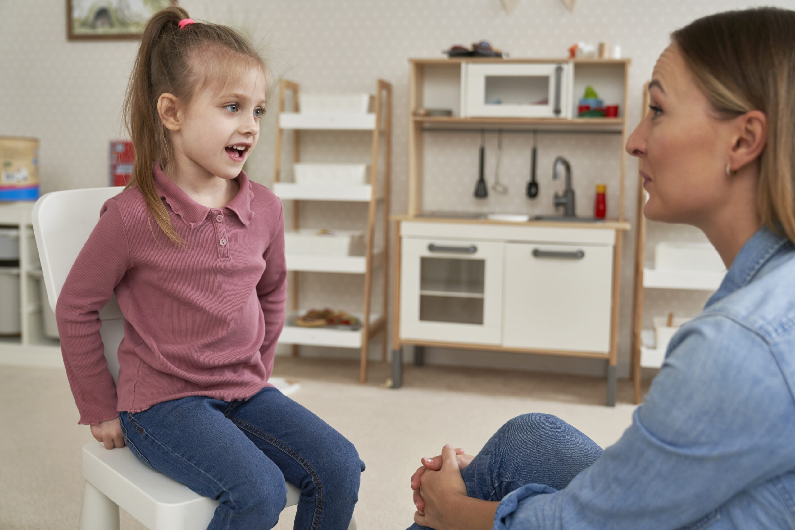 Applied behavior analysis therapist working with a young child on communication skills.