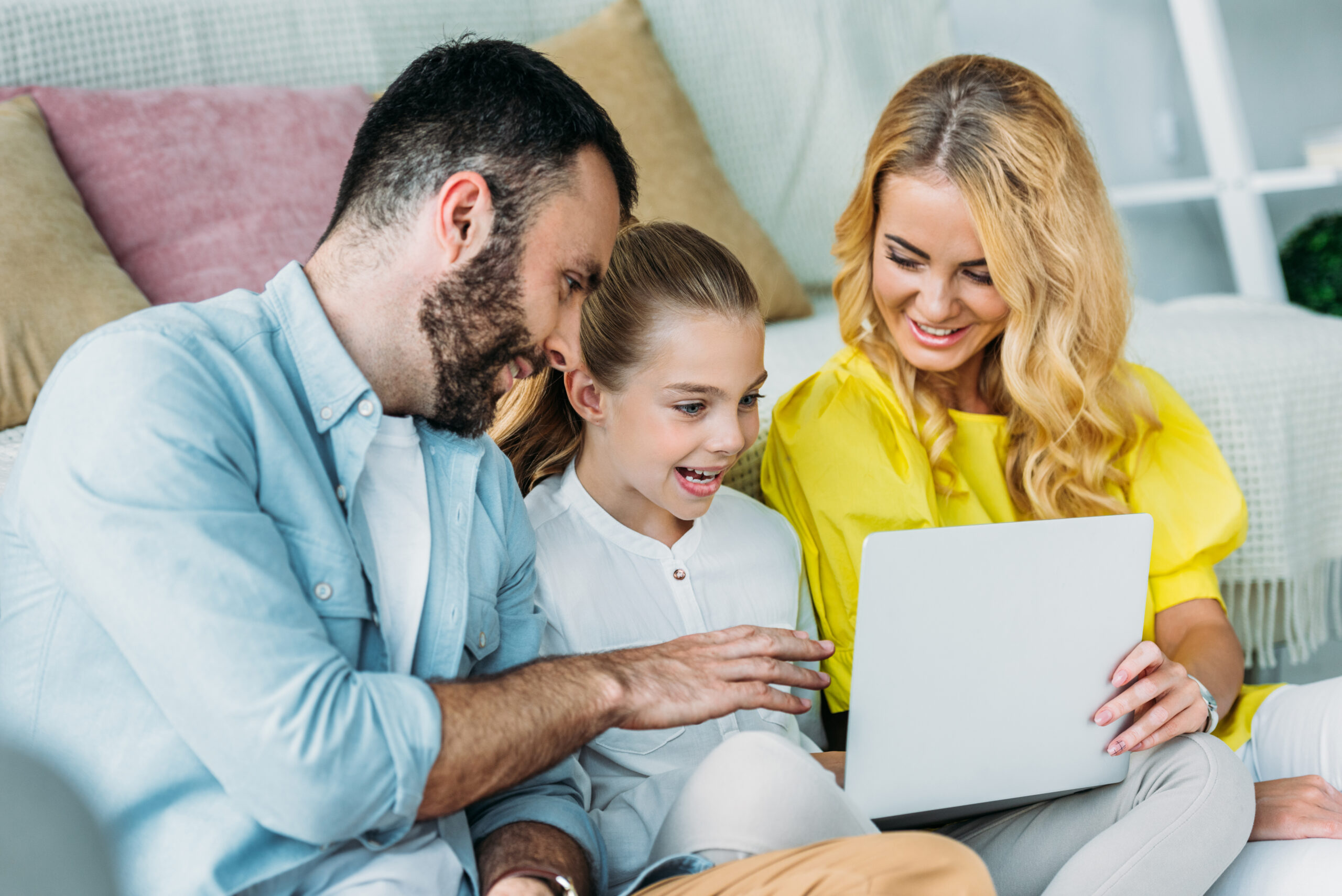 Family attending a virtual therapeutic consultation together from home.